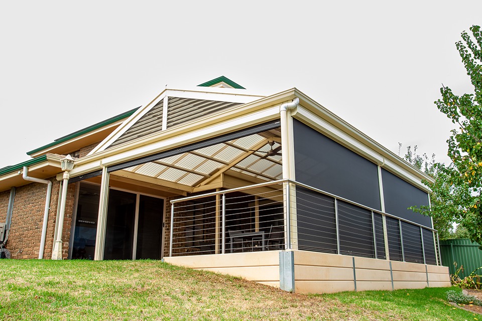 Gable verandah with outdoor blinds and a stainless balustrade on a raised deck
