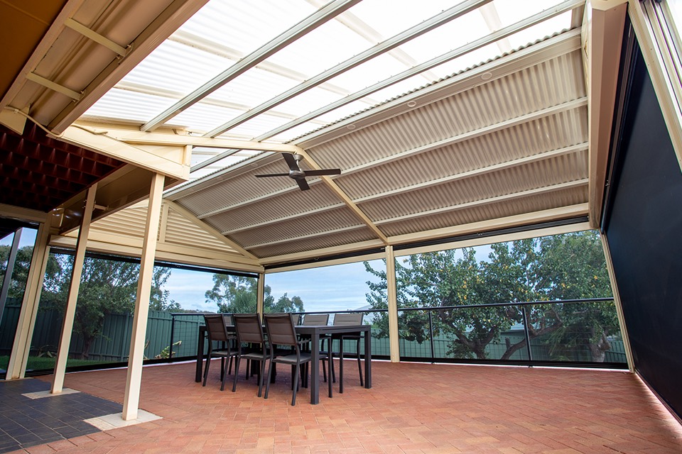 Gable verandah with roof lights and a ceiling fan over a paved dining area