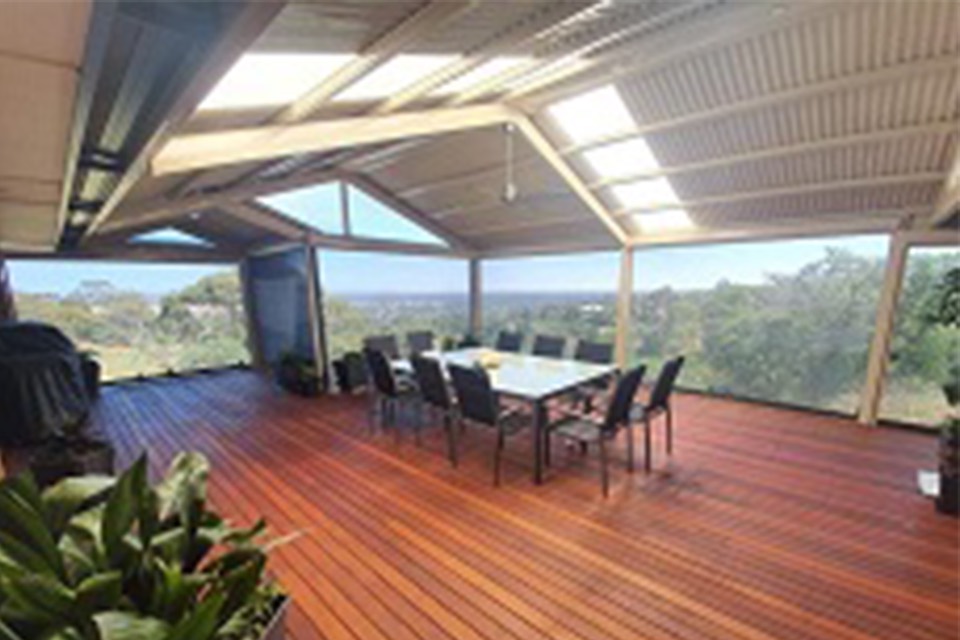 Gable verandah with roof lights over a timber deck with a hills view