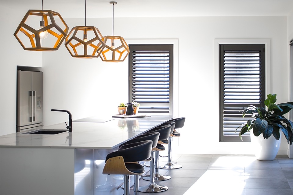 Charcoal plantation shutters on kitchen windows