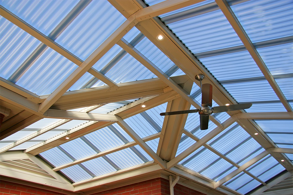 Pergola with a polycarbonate roof, downlights and a ceiling fan on steel beams